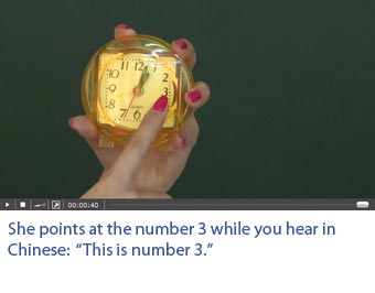Screenshot of a video with professional Chinese actors on which one sees what he hears. She points at the number 3. She says in Chinese: This is number 3.
